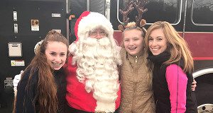 Santa took a moment to pose in front of a fire truck with three members of the community. Photos by Katie Turco Abate