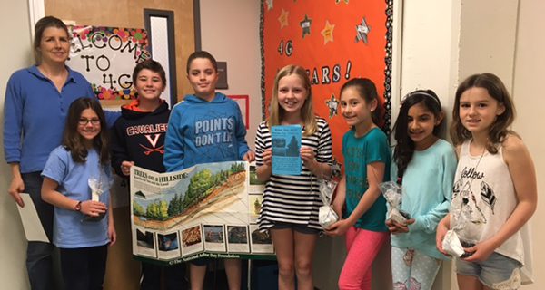 Rotarians distribute saplings to kids