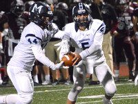 Williams, Warrior football roll in opener