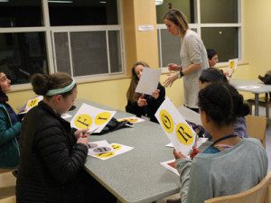 Head of Children’s Services Lizzy McGovern works with a group of volunteer teens to prepare for Harry Potter Night.  Photos by Laura Drinan