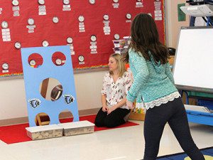 Nine-year-old Sophia tosses a football for a prize at one of the Winter Carnival’s many sports-themed activities. Photos by Laura Drinan
