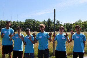 Volunteers get their hands dirty to help maintain the Needham Community Far. Photos by Daniel Curtin