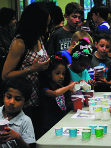 Kids mixed vanilla extract with sugar and cream to start the ice-cream-making process. Photos by Daniel Curtin 