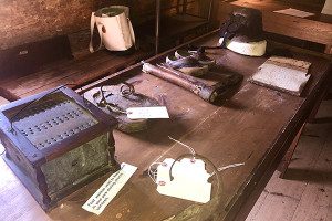 A table full of colonial-era artifacts in the Peak House allows visitors to explore and learn about history up close. Photos by Rachel Gore 