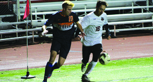 Aidan Murray (10) fights an Oliver Ames defender for a ball during the Rebels’ 2017 South quarterfinal matchup in Easton.
