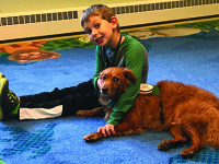 Children read to therapy dog