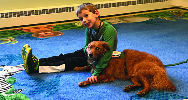 Children read to therapy dog