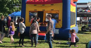 Kids play on a bounce house at the Harvest Fair.