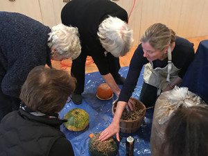 Owner of The Captured Garden Deborah Trickett shows members of the Garden Club how to make a succulent pumpkin centerpiece during her workshop.