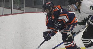 Mike DiCenzo (11) fights off a Mansfield fore-checker and gets the puck up the boards. 