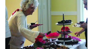 After looking over the entire spread, a senior opts for a brownie…