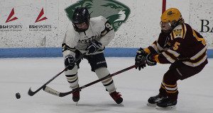 Sophomore forward Caroline Han (9) corrals a loose puck and fights off a stick check midway through the second period. 