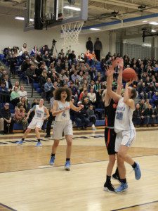 Sophomore Camilla Silk (20) drives for 2 of her 13 points. 