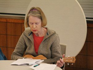 Marie Taylor sings along to the sheet music despite not having her glasses.
